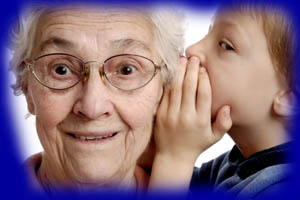 boy whispering to great-grandmother